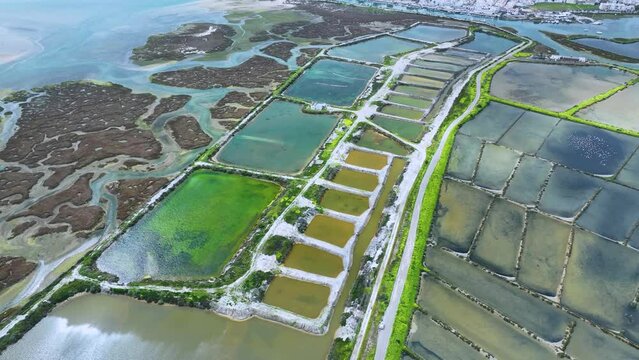 Landscape in Fuseta. Salt pans and marsh in Fuseta in the district of Faro. Aerial view from a drone. Marshes and salt flats of the Ria Formosa Natural Park. Atlantic Ocean. Algarve. Portugal. Europe