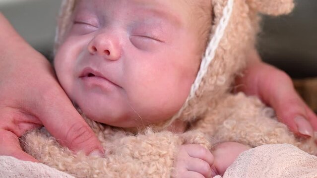 Sleeping newborn beautiful cute baby girl or boy before photo session during first week of life. 4k slow motion raw video. Happy Family concept. Small baby at wicker basket sleep in warm lamb costume