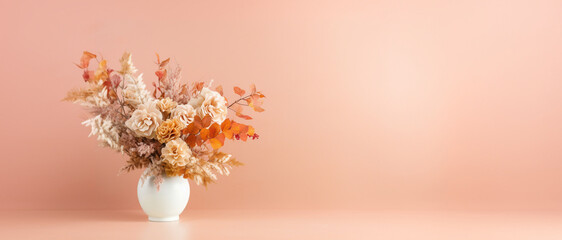 Autumn bouquet with elegant dried flowers in a white vase with space for text