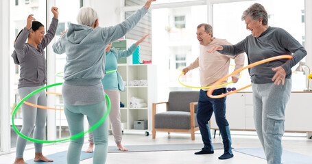 Fitness, senior and people with hula hoop at the gym for training, workout and health in...