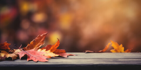 Autumn leaves on wooden table with bokeh background. Fall concept