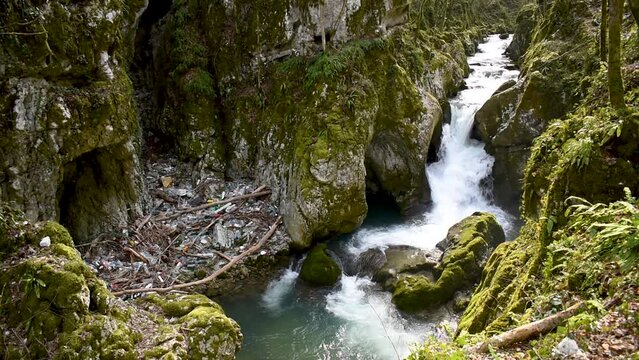 Waterfall and waste on mountain stream, Svrakava stream in rural area near Banja Luka and plastic pollution
