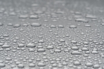 Close up water drop on siver metallic surface.