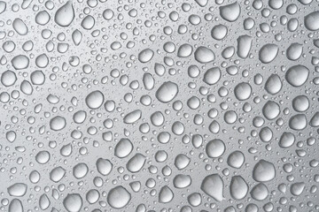 Close up water drop on siver metallic surface.