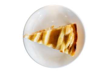 Top view, Piece of Apple tart with caramel on the plate on isolated white background. Sweet food.