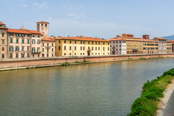 Beautiful sight in Pisa with the Arno River on a sunny summer day. Tuscany, Italy.