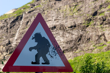 Funny troll warning sign at the parking place at the road Trollstigen. Norway