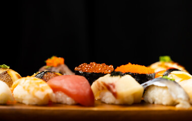 Assorted japanese sushi food. sushi with tuna, crab, salmon, eel and rolls. Japanese food isolated on wood background