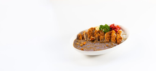 Curry topped with fried pork.  spicy curry meat food in plate with rice. Japanese food on restaurant table