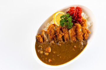 Curry topped with fried pork.  spicy curry meat food in plate with rice. Japanese food on restaurant table