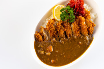 Curry topped with fried pork.  spicy curry meat food in plate with rice. Japanese food on restaurant table