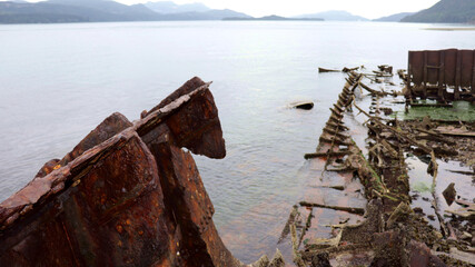 old rusted out shipwreck used as a breakwater on the Johnstone strait