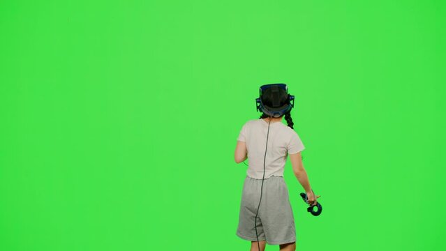 Child in cyberspace get immersive experience on chroma key green screen. The little girl design artist VR headset creation 3d virtual reality world. Concept VR immersive experience in virtual reality