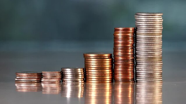 A panning shot of money and coins on a table. 