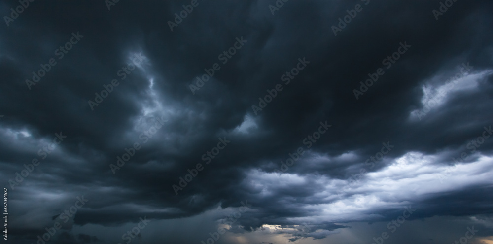 Poster the dark sky with heavy clouds converging and a violent storm before the rain.bad or moody weather s