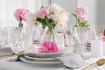 Stylish table setting with beautiful peonies in dining room