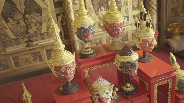 Top view of beautiful ancient traditional Thai pattern Pantomime or Khon masks are set up on wooden shelves with various styles of charactor.