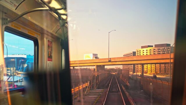 Approaching shot of beautiful skyscrapers and railway at sunset Subway train approaching to huge skyscrapers by railway Concept view from windshield subway wagon to aesthetic urban landscape at sunset