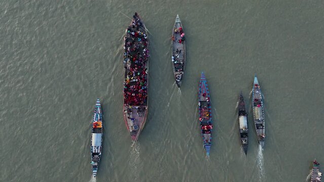 The aerial shot of boats crossing the Jamuna River in Bangladesh is a breathtaking sight. The mighty river snakes its way through the lush green landscape, carrying with it the lifeblood of the nation