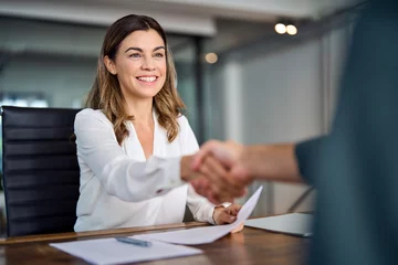 Crédence de cuisine en verre imprimé Vielles portes Happy mid aged business woman manager handshaking at office meeting. Smiling female hr hiring recruit at job interview, bank or insurance agent, lawyer making contract deal with client at work.