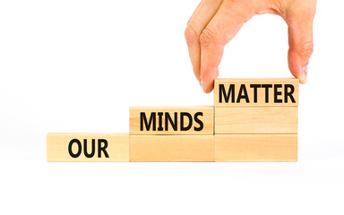 Our minds matter ourmindsmatter symbol. Concept words Our minds matter on wooden block. Beautiful white table white background. Businessman hand. Our minds matter ourmindsmatter concept. Copy space.