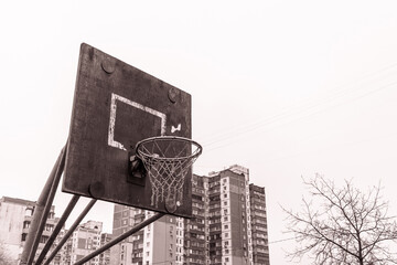 An old basketball hoop in a poor area of the city. Old streetball basket