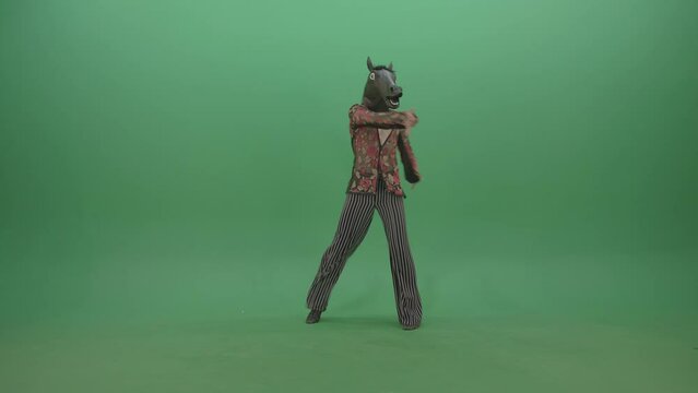 Funny man in horse mask dancing latin moves on green screen, comedy chroma key footage for memes