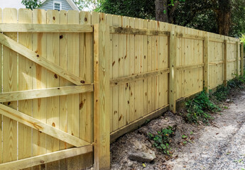 New wood fence facing urban alley.