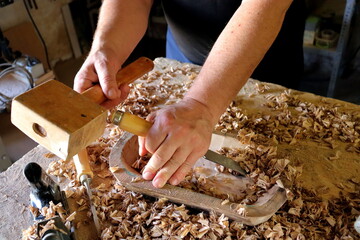 Hands with a tool on the background of a carpentry workshop. Photo in high quality. 