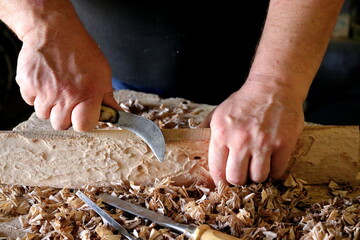 Hands with a tool on the background of a carpentry workshop. Photo in high quality. 