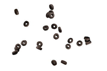 Chocolate rings cereal spill out into a bowl. Breakfast.