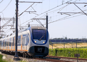 Fototapeta premium SLT commuter train on railroad track near Zwolle