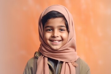 Portrait of a cute little boy with hijab smiling at the camera