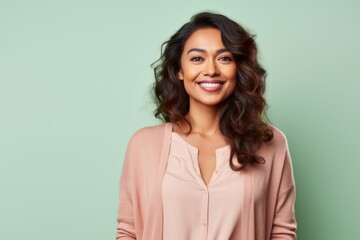 Fototapeta premium smiling african american woman in beige clothes over green background