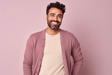 Obraz premium Portrait of a handsome young man smiling at camera while standing against pink background