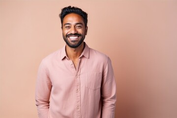 Fototapeta premium Portrait of a happy indian man smiling and looking at camera
