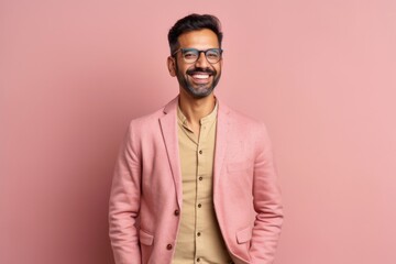 Obraz premium Portrait of a young indian man in a pink suit and glasses