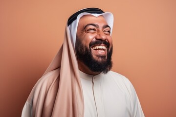 Obraz premium Portrait of arabic man laughing. Isolated on brown background