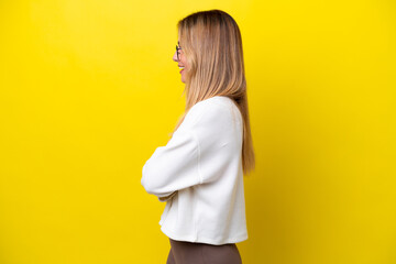 Young Uruguayan woman isolated on yellow background in lateral position