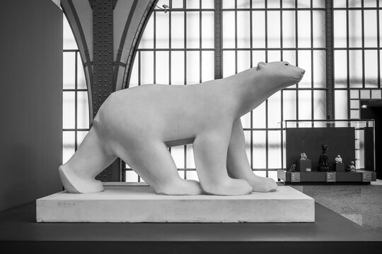 PARIS, FRANCE - APRIL 15, 2023: White Bear, French: Ours blanc, sculpture by Francois Pompon, 1927. Main hall of Orsay Museum, French: Musee d Orsay, in former train station building, Paris, France.