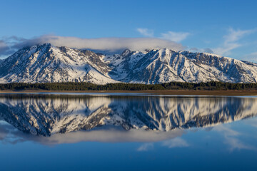 Fototapeta na wymiar Scenic Landscape Reflection of the Teton Range in Springtime in Jackson Lake