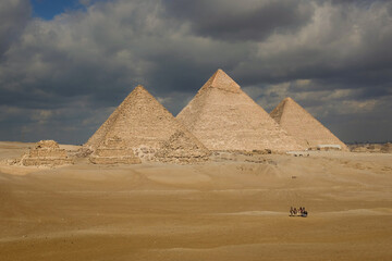 Fototapeta na wymiar Giza Pyramids on a rare cloudy day - Cairo, Egypt 
