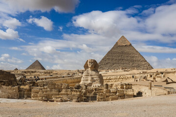 Fototapeta na wymiar Giza Pyramids and Sphinx on a rare cloudy day - Cairo, Egypt 