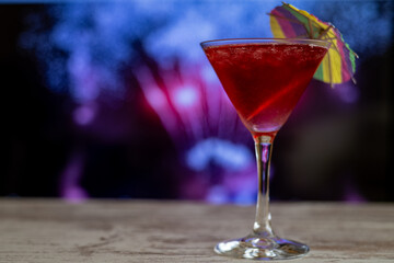 Cosmopolitan In A Beach Bar At Dusk, With People In The Background Out Of Focus. Copy Space