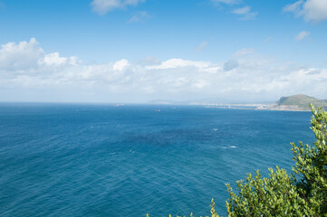 Serene seascape with distant coastal cliffs.