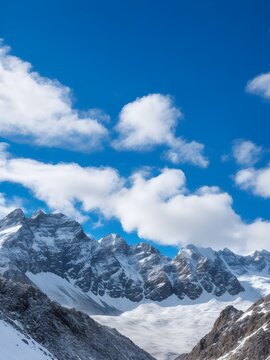 a view of a snowy mountain range with clouds and blue sky Generative AI