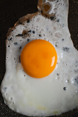 Top view of a fried egg on a pan in the morning while preparing breakfast