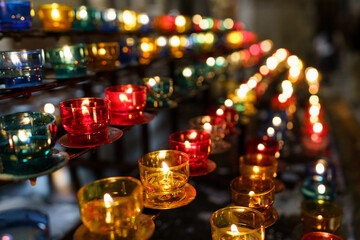 Fototapeta na wymiar Beautiful, colorful small glass candles whose flame gives an amazing atmosphere.