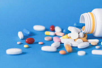 Pills on a blue, medical background