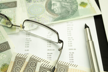 Money and receipts on the table, glasses with business papers